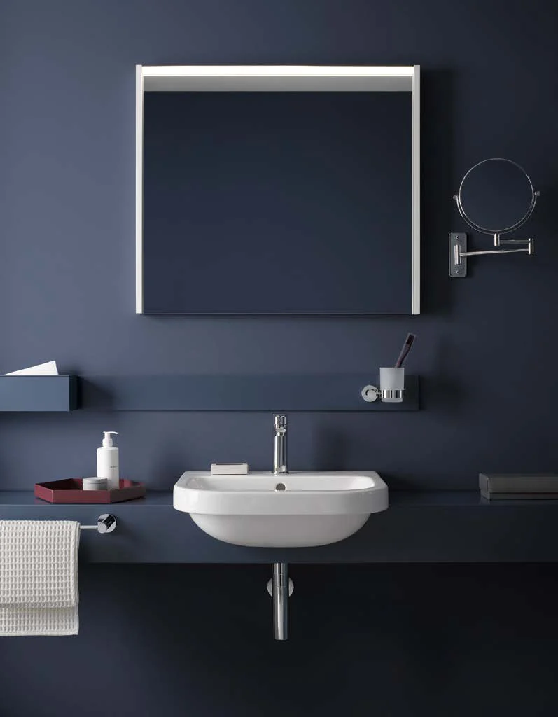 Navy bathroom with washbasin and cosmetic mirror
