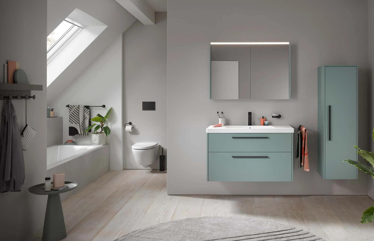Family bathroom under a sloped roof with sage green furniture