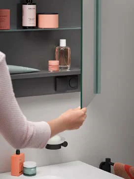 Mirror cabinet detail with hand