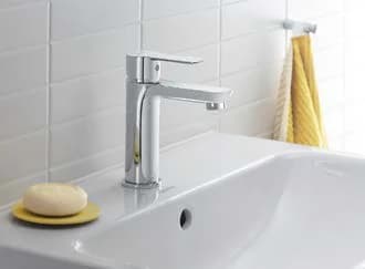 Chrome faucet on a washbasin with soap