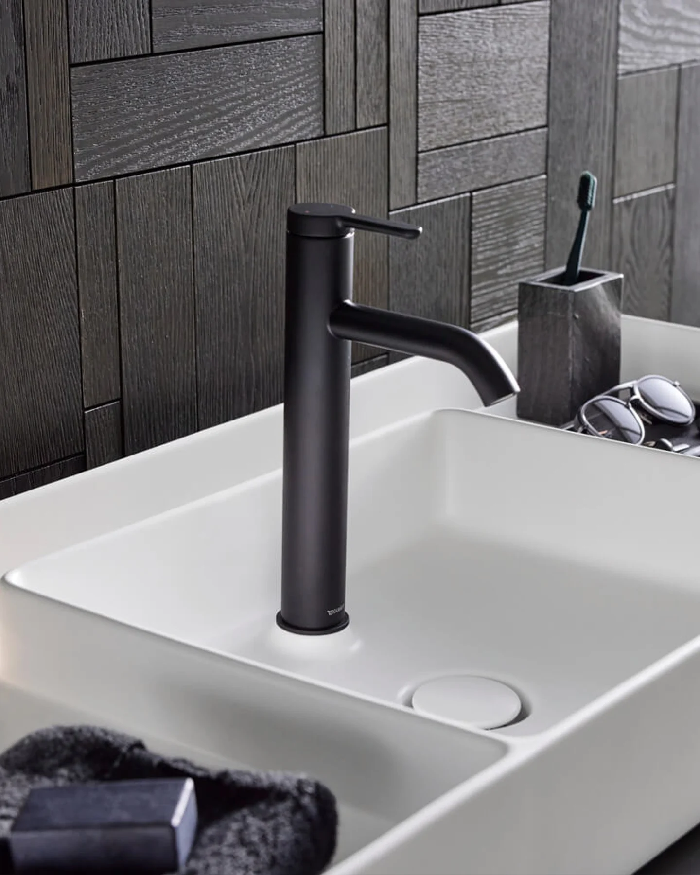 Matt black tall mixer on a white washbasin