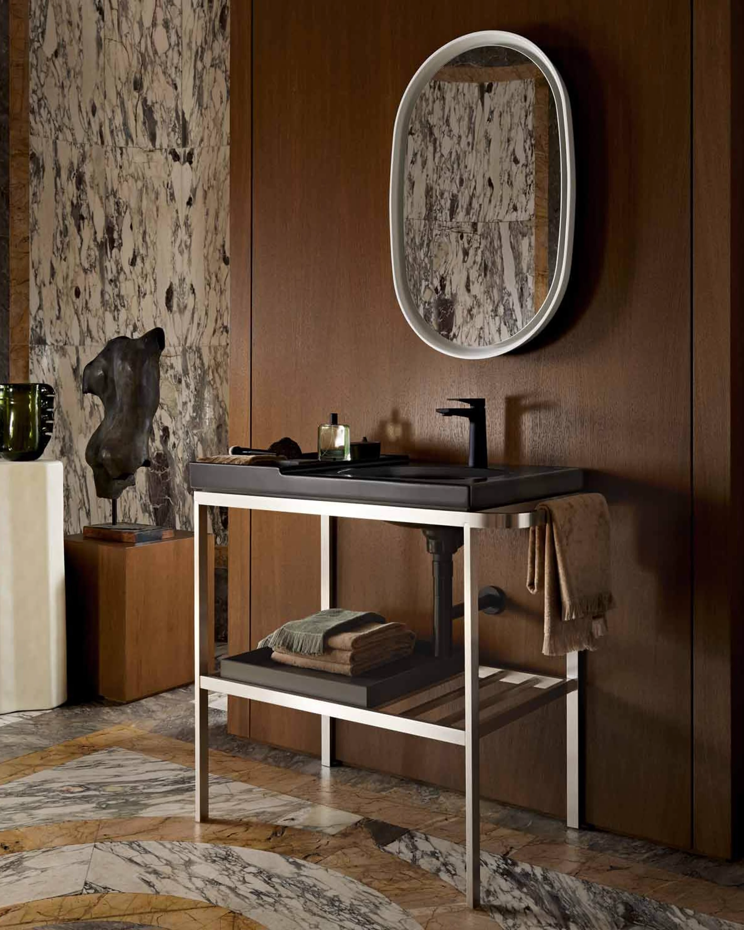 Aurena washplace in dark walnut with a marble wall and an oval mirror