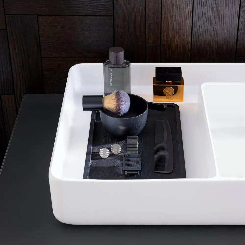 Wide white basin styled with dark accessories