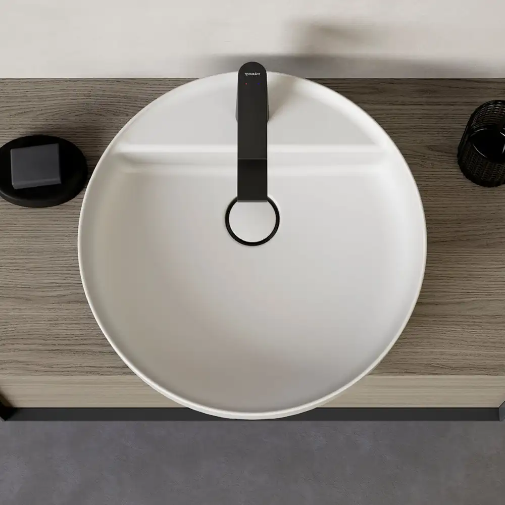 Round white bowl on timber, seen from above