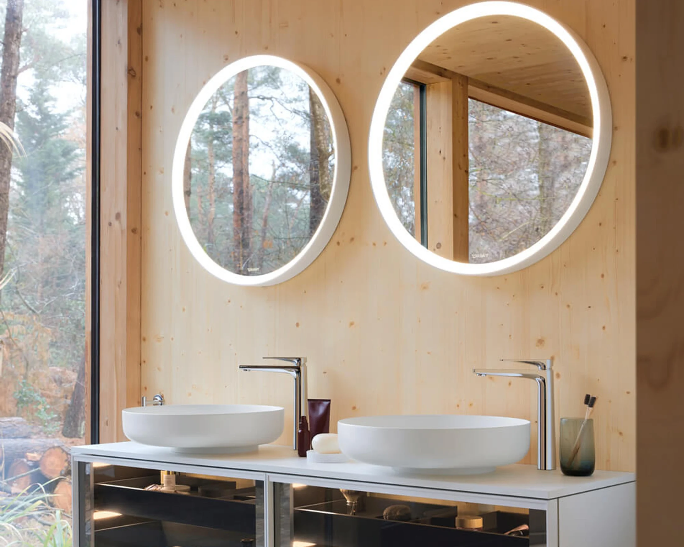 Vitrium bathroom with glass-fronted vanities in warm timber