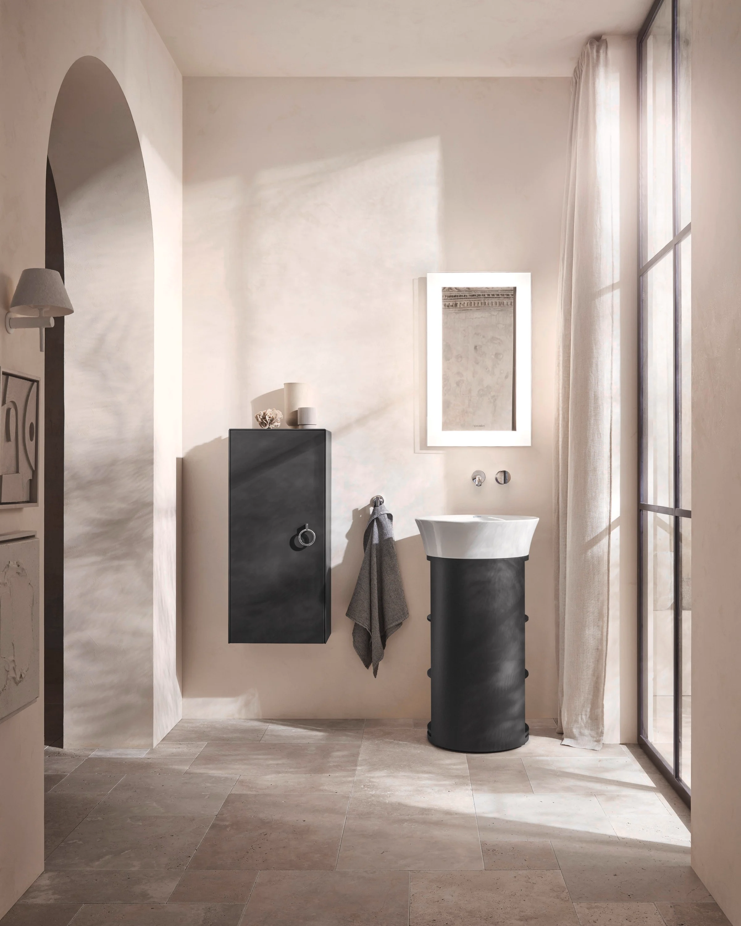 White Tulip pedestal basin under a bright arch on travertine