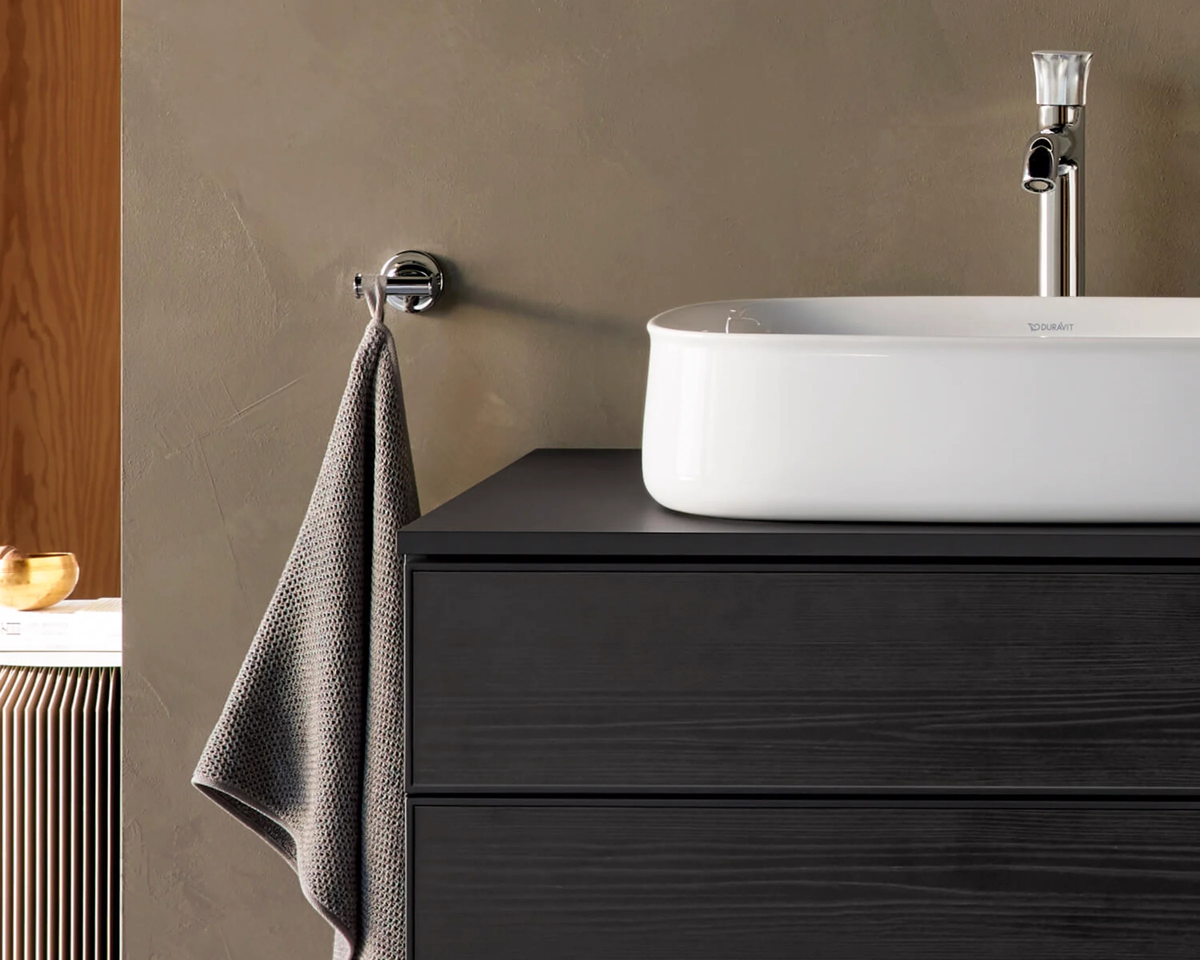 Chrome faucet over a white basin on a black Zencha vanity