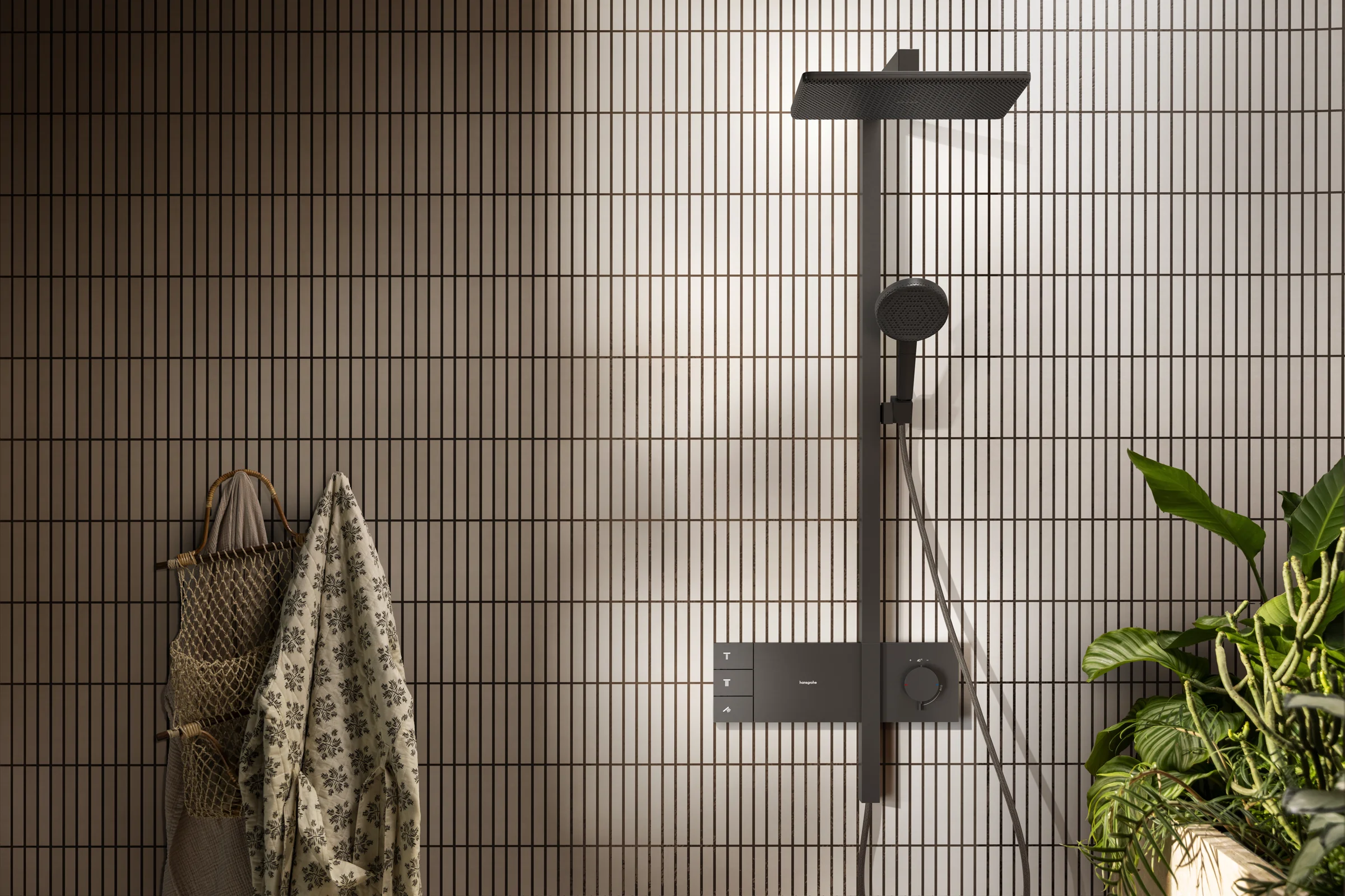 Shower zone with a black hansgrohe shower column on light slim tiles