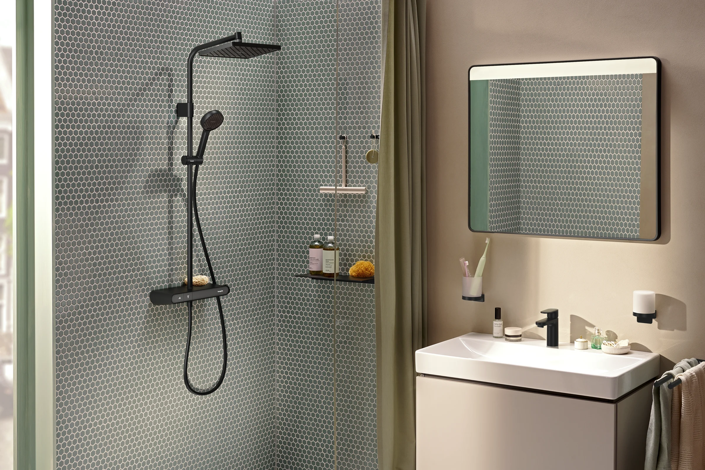 Green mosaic shower with a black shower column and an olive curtain